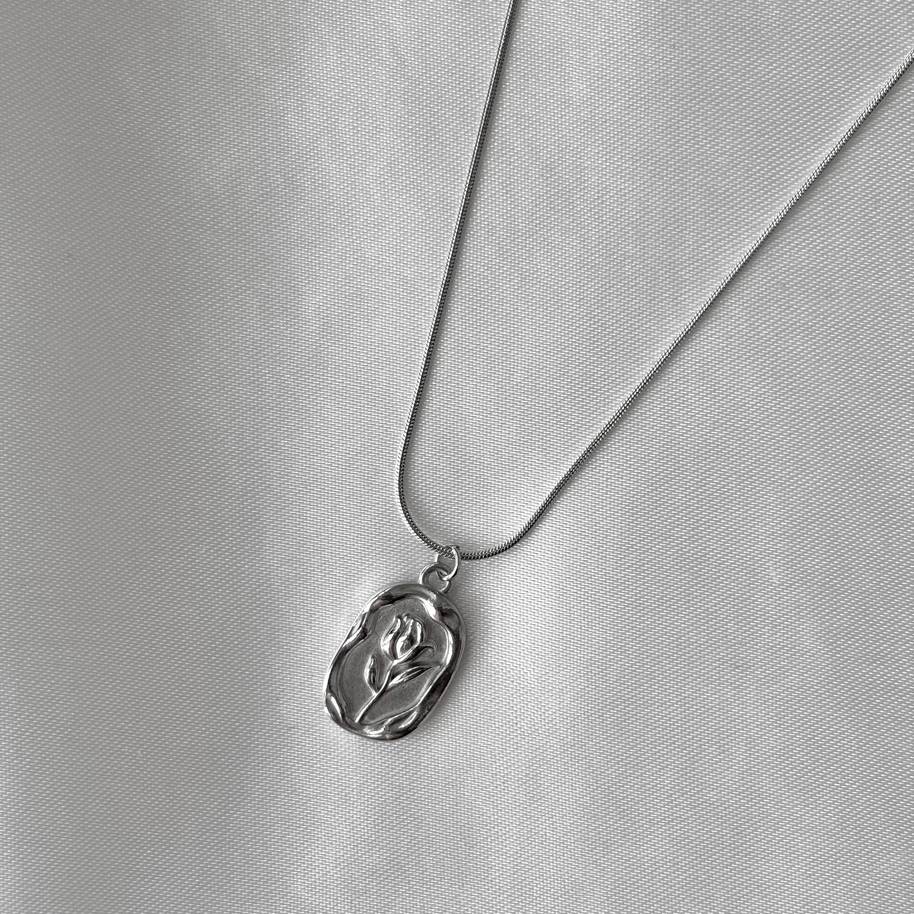 Stamped flower pendant